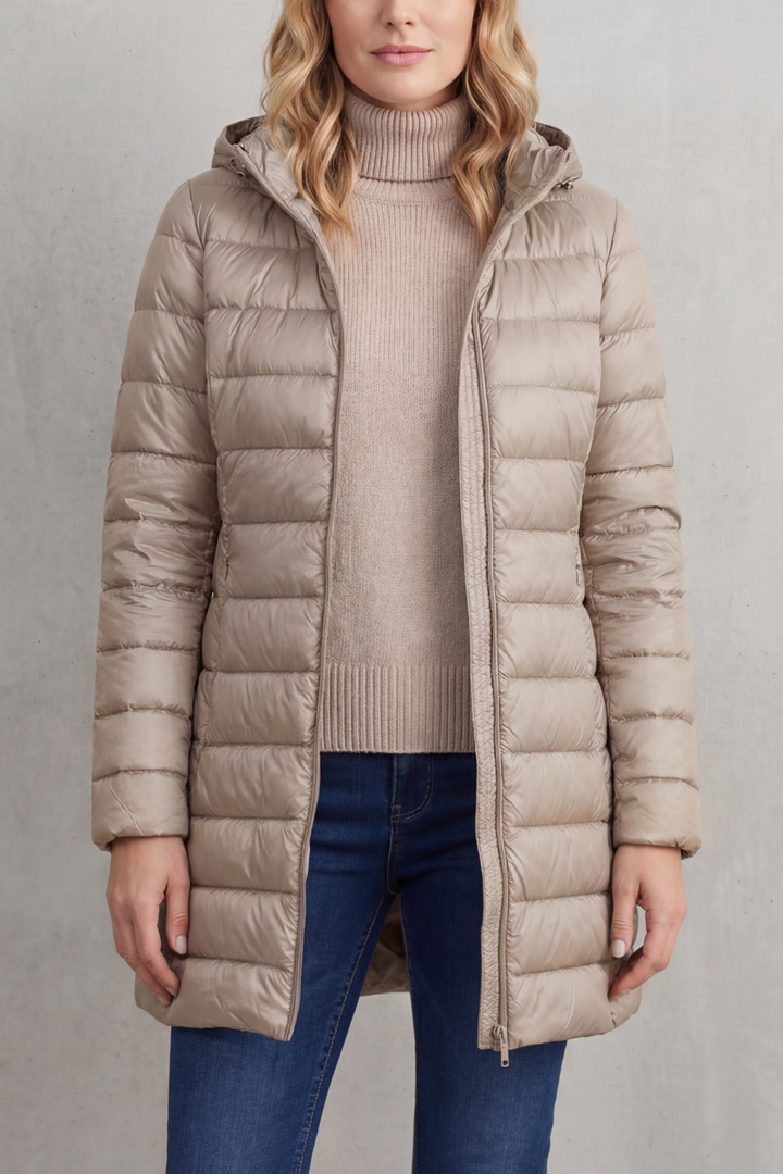 Women's stylish puffer jacket, hooded & lightweight. Essential warm outerwear for winter fashion & travel.