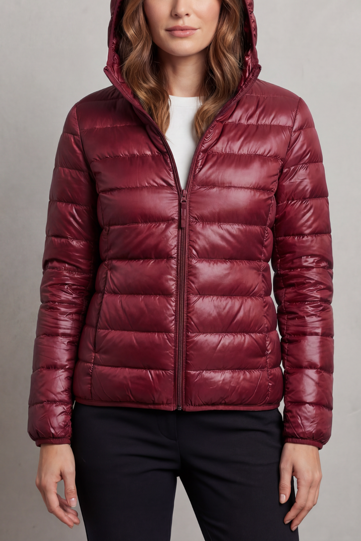 Durable women's hooded puffer coat, ultralight & packable, perfect for outdoor travel.