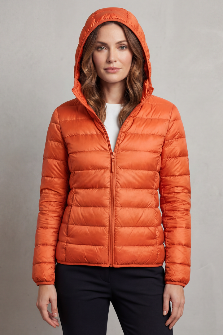Comfortable women's ultralight hooded puffer, packable for adventure or casual wear.