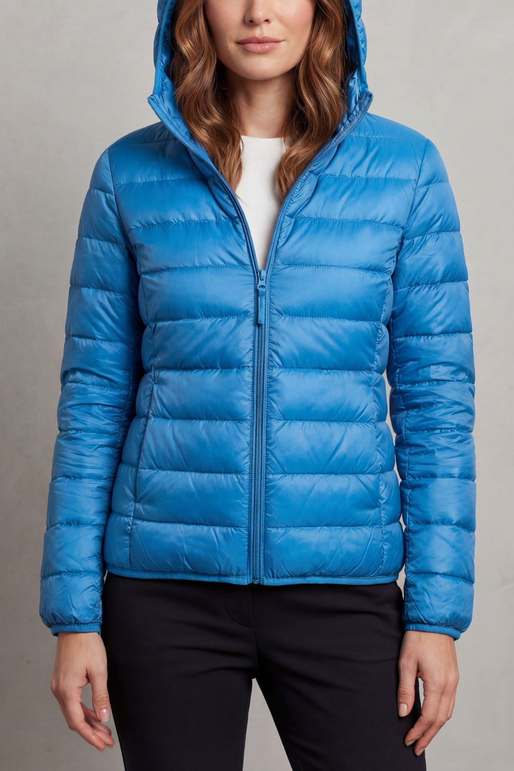 Women's sleek ultralight packable puffer jacket with hood, perfect for urban travel.