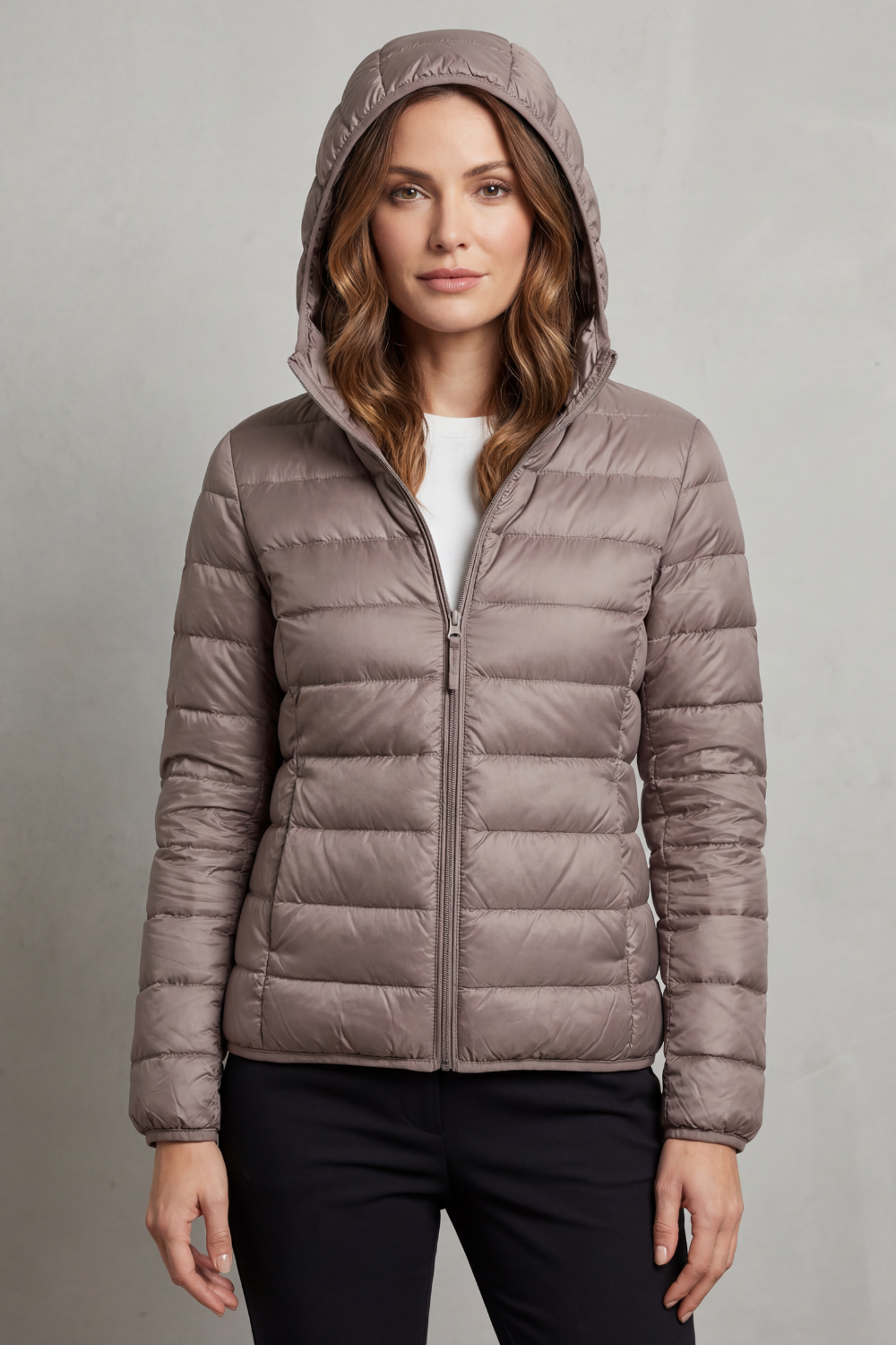 Lightweight women's puffer jacket with hood, packable design for easy travel & everyday wear.