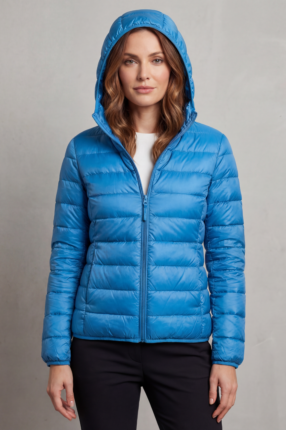 Women's outdoor ultralight hooded puffer, packable, ideal for camping or cool weather excursions.