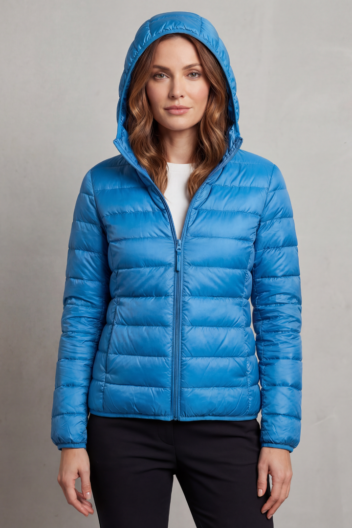Women's outdoor ultralight hooded puffer, packable, ideal for camping or cool weather excursions.