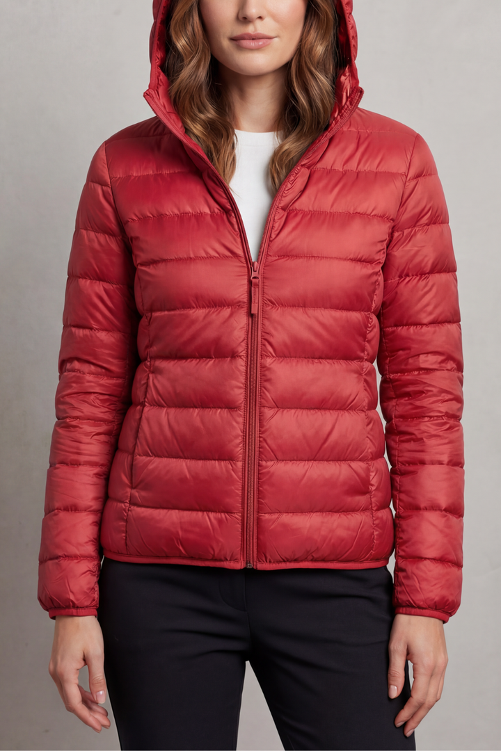 Women's streamlined ultralight packable hooded puffer, perfect for minimalists & travelers.