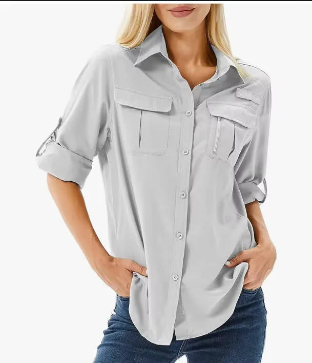 Breathable women's UPF 50 hiking shirt with roll-up sleeves and secure zip pockets for sun protection.