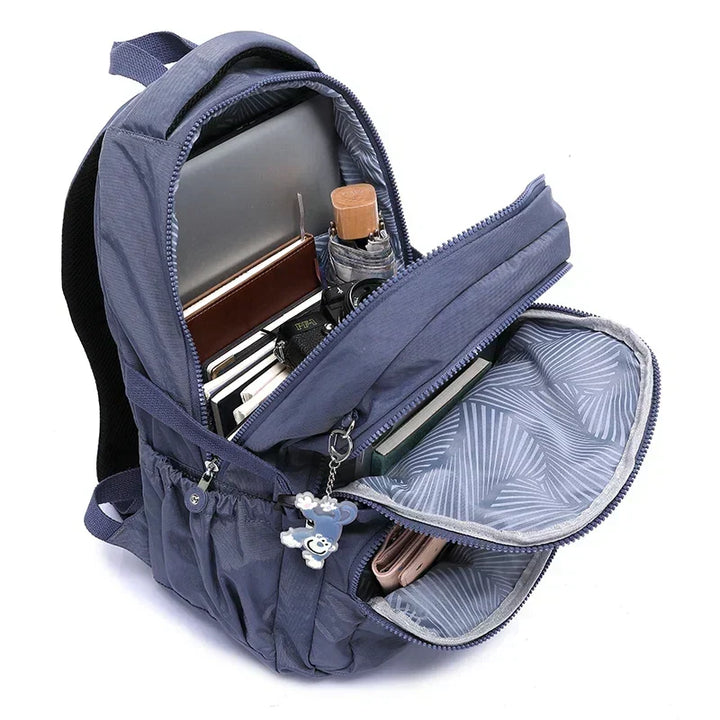 Durable women's everyday backpack, black nylon, water-resistant, with smart organizer.