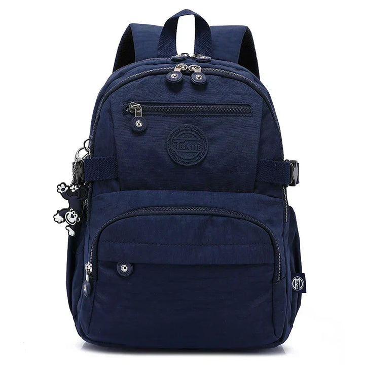 Durable water-resistant nylon backpack for women, ideal for urban commuting.
