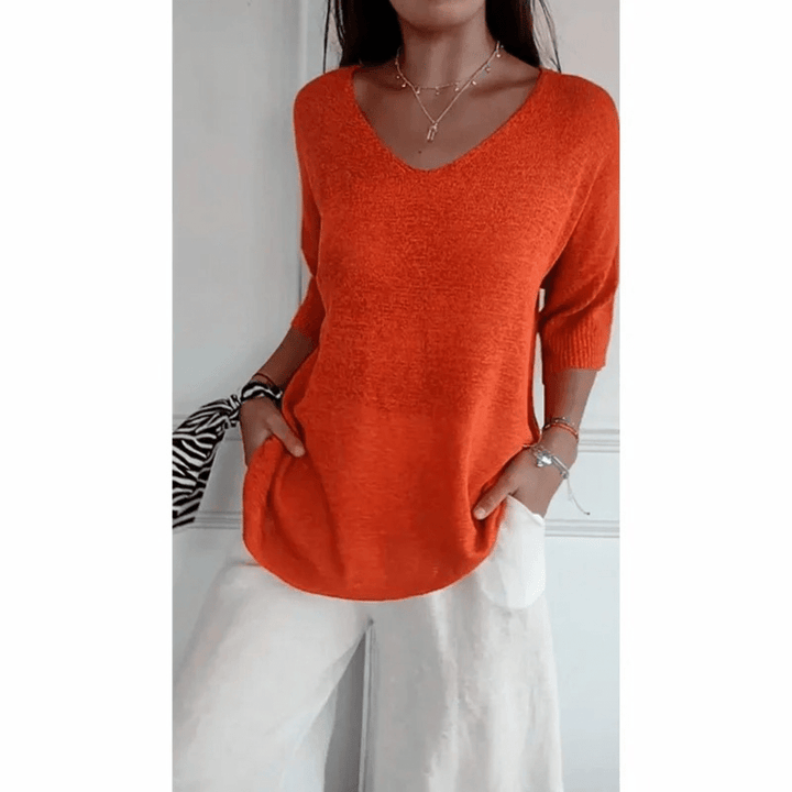 Women's V-neck 3/4 sleeve top, perfect for casual everyday wear. Comfortable & versatile blouse.