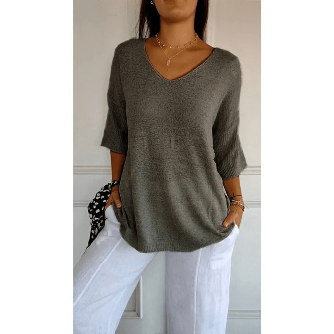 Women's V-neck blouse with 3/4 sleeves, offering relaxed fit & casual style for daily wear.