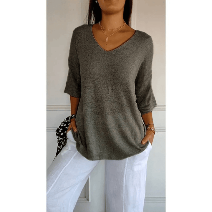 Women's V-neck blouse with 3/4 sleeves, offering relaxed fit & casual style for daily wear.