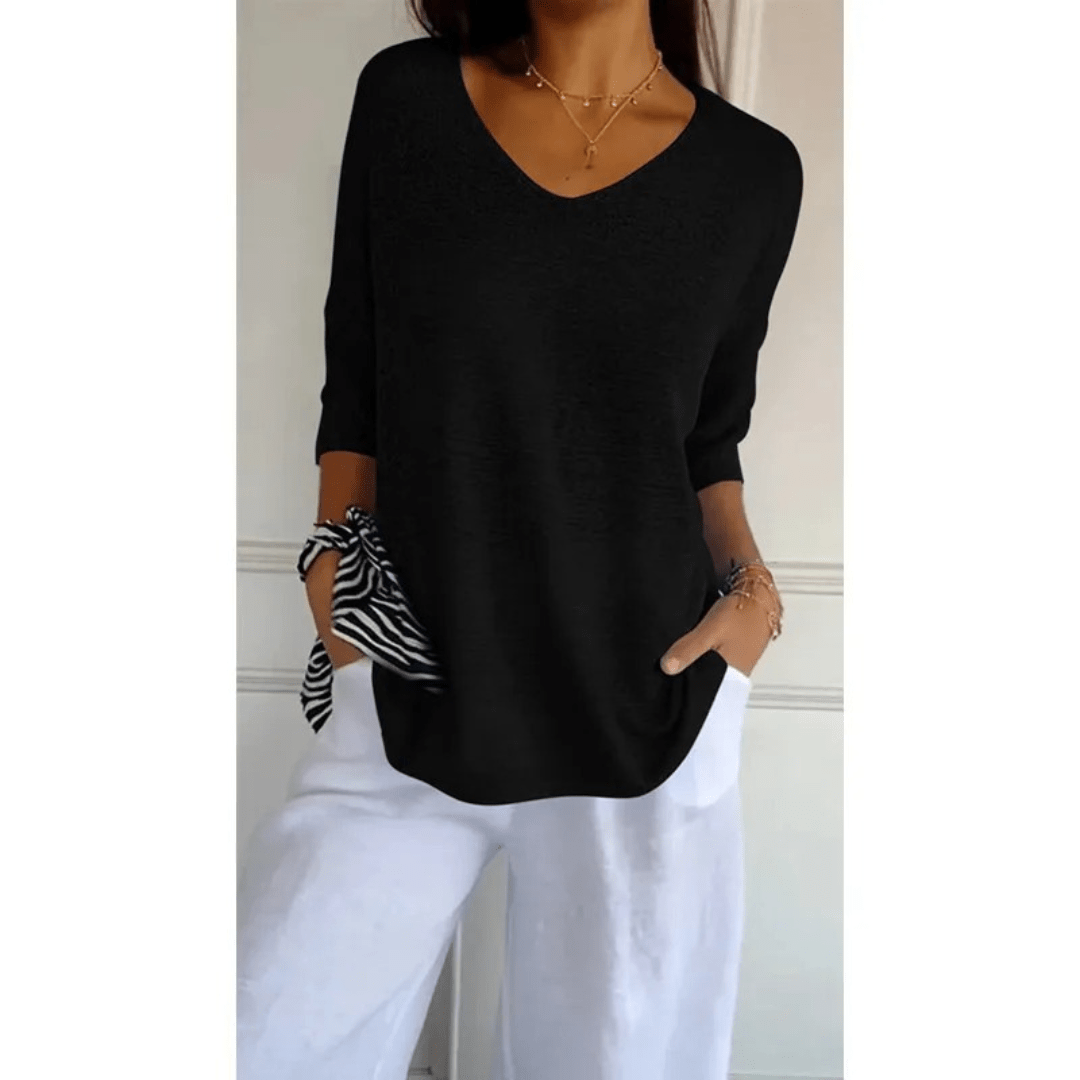 Modern women's 3/4 sleeve V-neck top. Casual, comfortable, & versatile for everyday outfits.