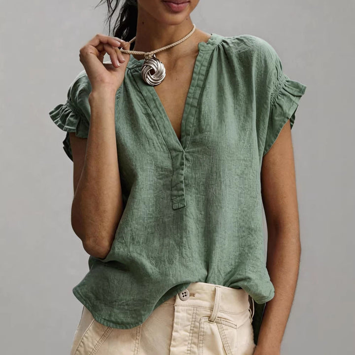 Casual women's V-neck blouse, relaxed fit with ruffle cap sleeves. Perfect chic summer top.