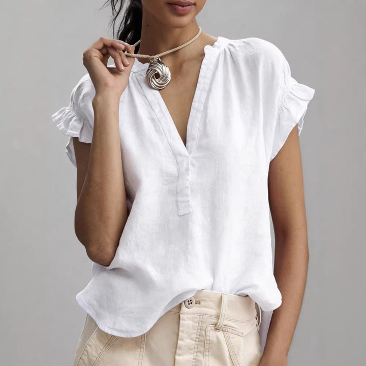 Relaxed fit women's V-neck blouse with ruffle cap sleeves & button placket, perfect casual top.