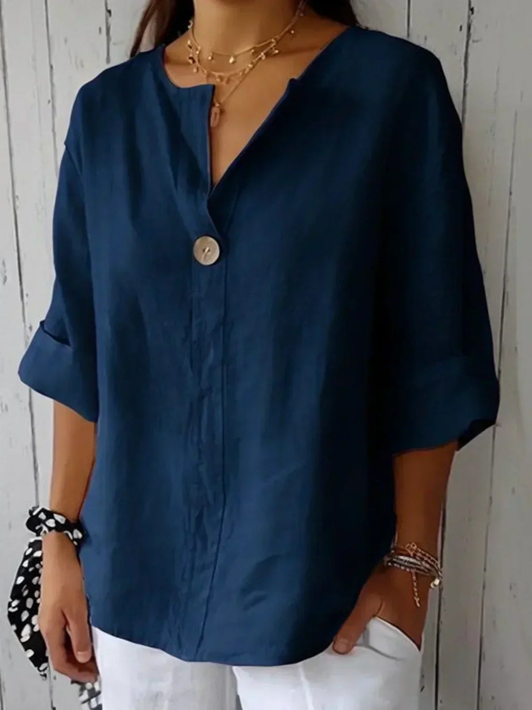 Effortless women's relaxed fit V-neck blouse with roll sleeves, ideal for comfortable daily wear.