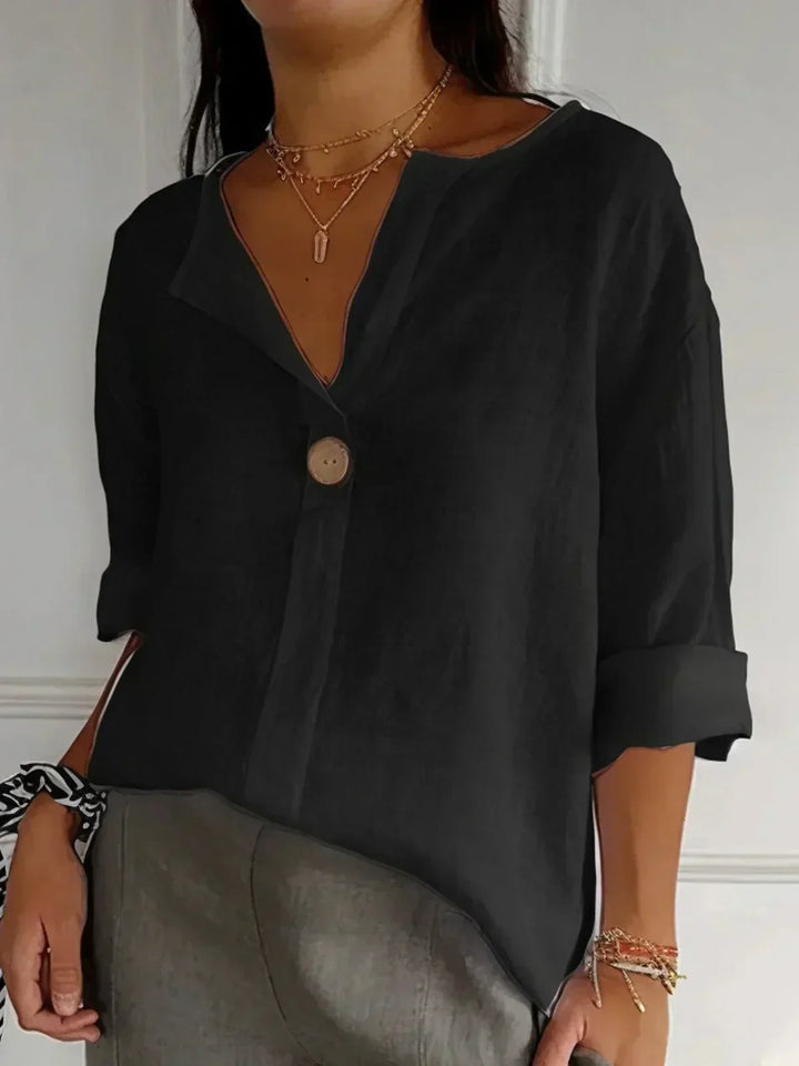 Lightweight women's V-neck blouse with roll sleeves & button-down front, perfect for spring/summer.