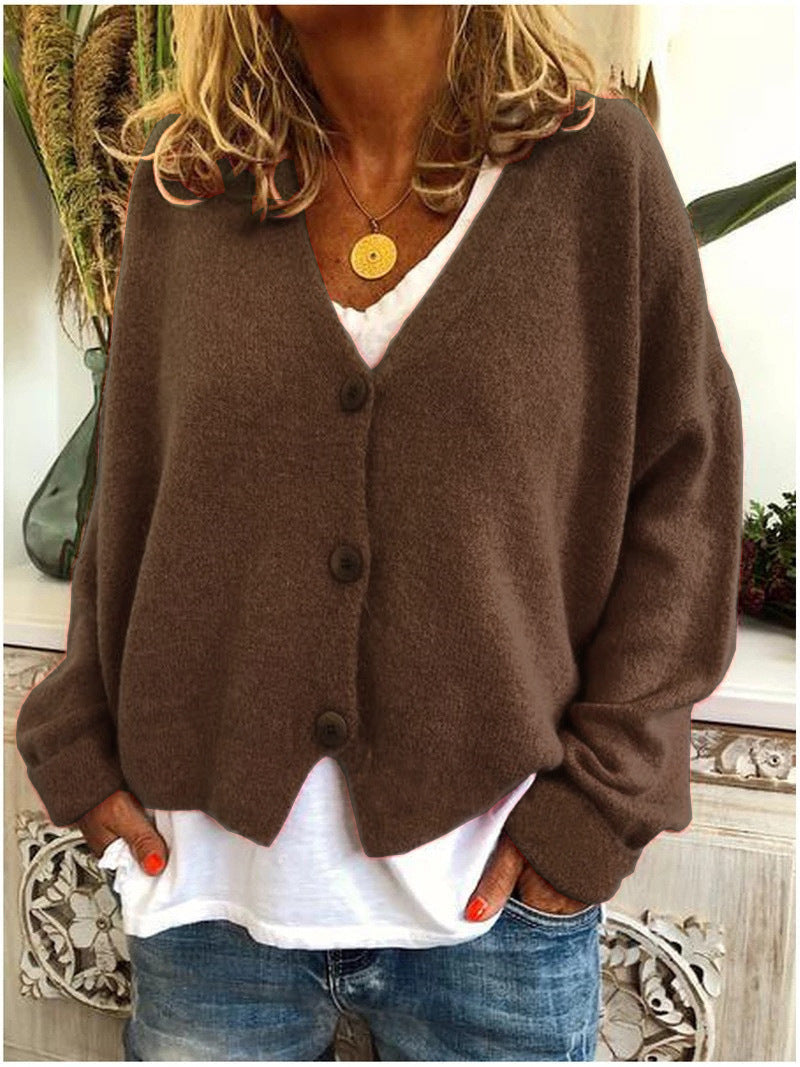 Cropped women's V-neck cardigan with buttons, offering a modern and cozy layered look.