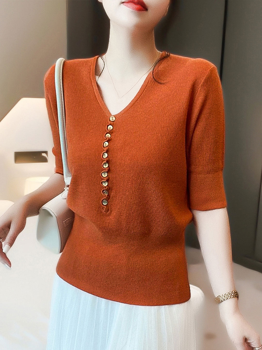Soft knitted V-neck top for women with buttons. Provides comfortable, casual, and effortless everyday style.