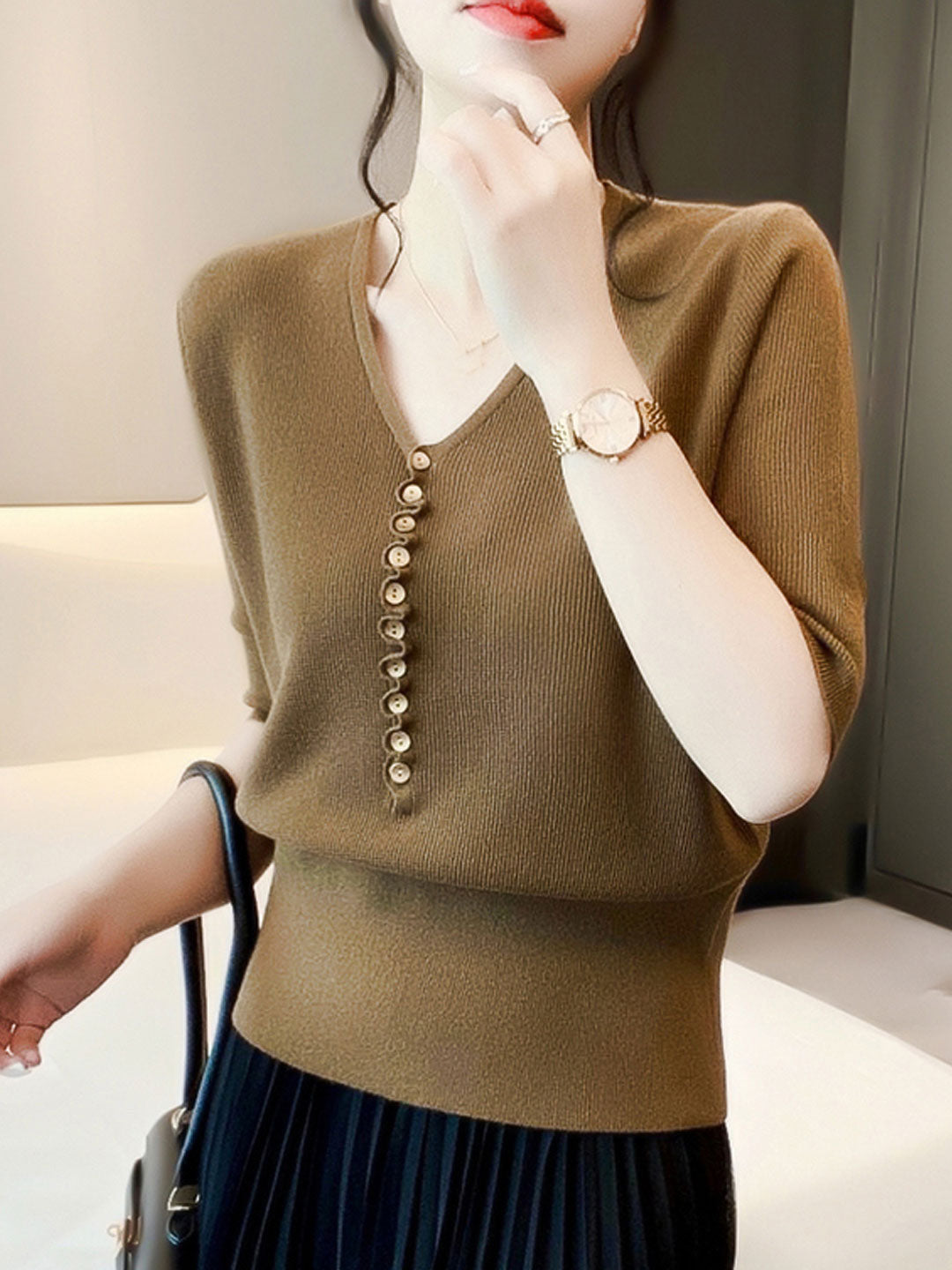 Versatile women's V-neck button-up knitted top. Ideal for comfortable, casual, and effortless everyday fashion.