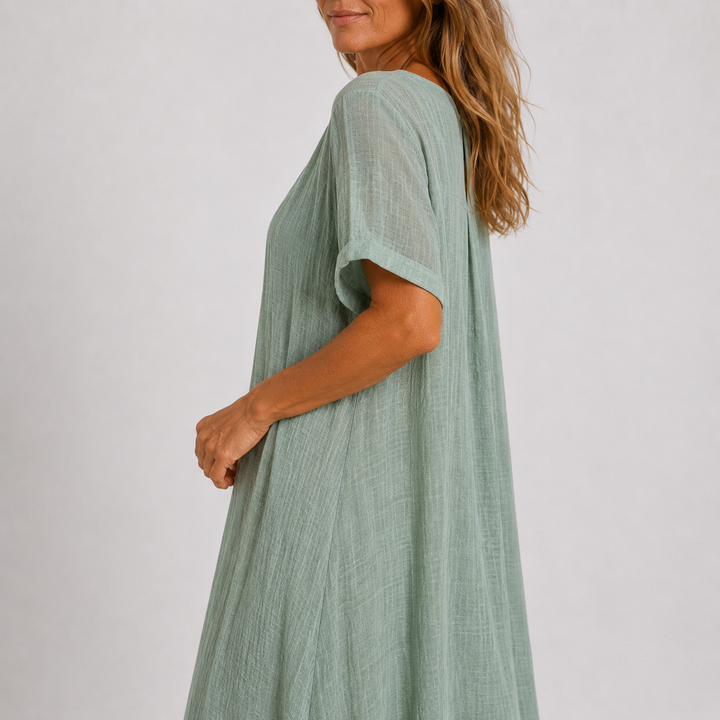 Relaxed fit women's V-neck maxi dress with rolled sleeves. Effortless flowy design for chic summer fashion.