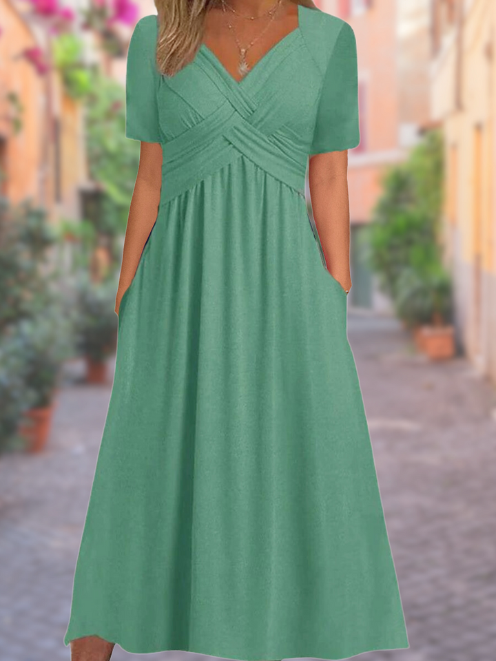 Comfortable V-neck tummy-covering flowy dress in a vibrant color, ideal for summer occasions.