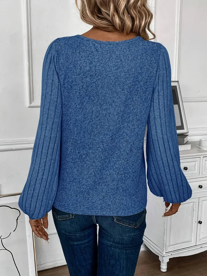 Fashion-forward women's V-neck knit top with statement lantern sleeves. A must-have long-sleeve sweater.