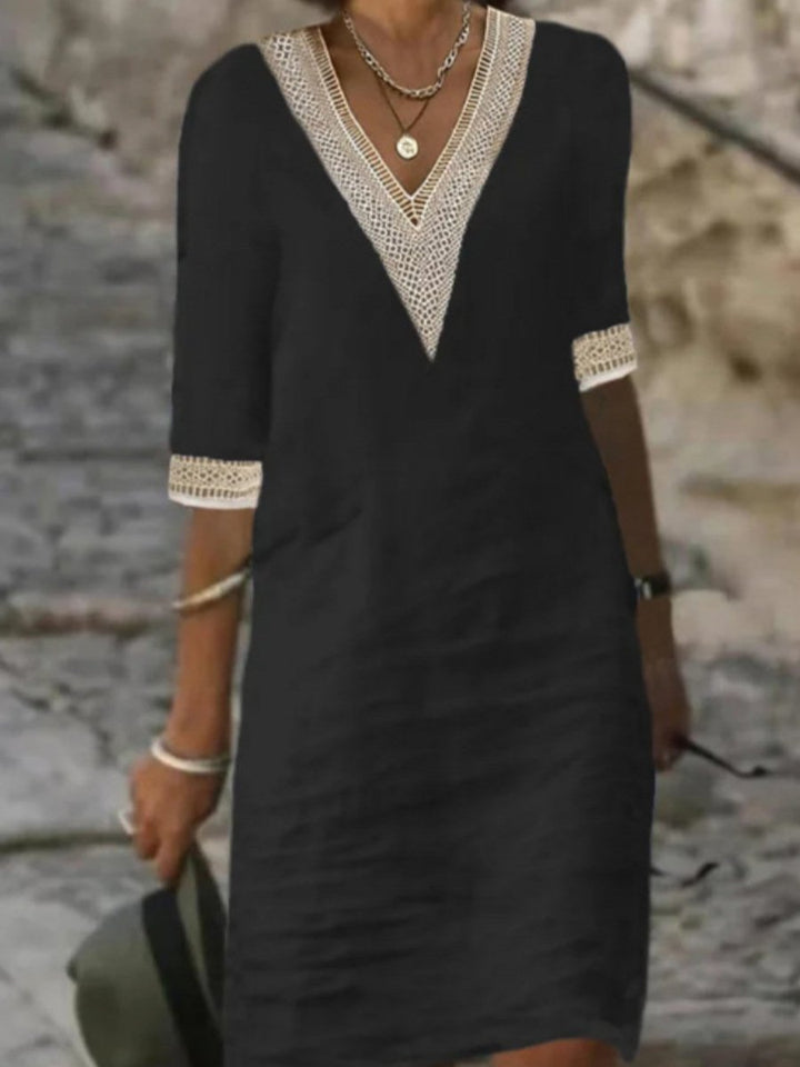 Fashionable women's V-neck midi dress, styled with elegant lace trim and practical 3/4 sleeves.