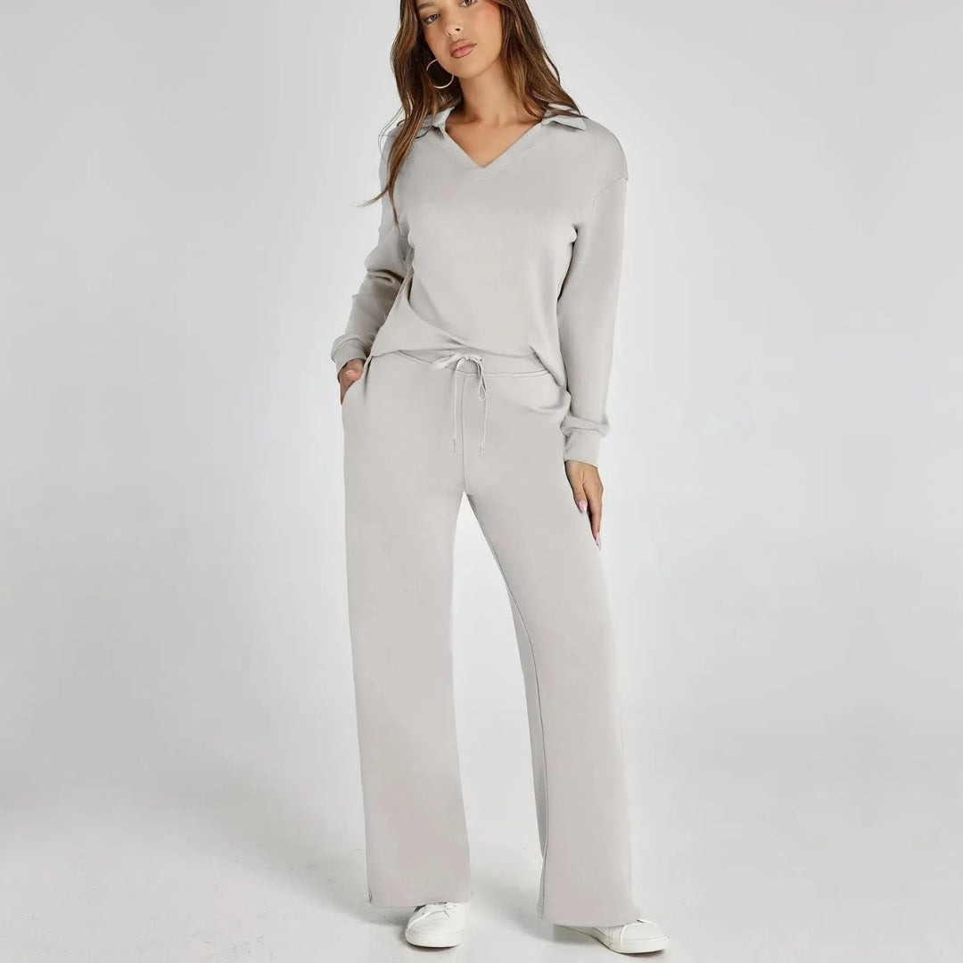 Model wearing a chic women's V-neck long sleeve loungewear set with flowing wide leg pants.