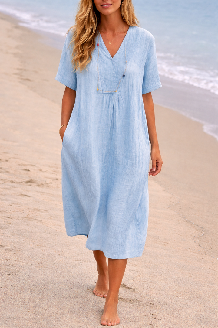 Elegant women's V-neck midi dress with pockets, suitable for casual spring outings and comfortable weekend wear.