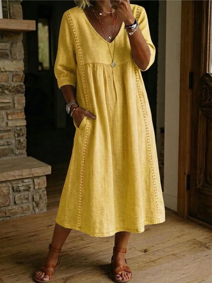 Stylish women's V-neck midi dress with pockets. Effortless design & comfortable fit for any occasion.