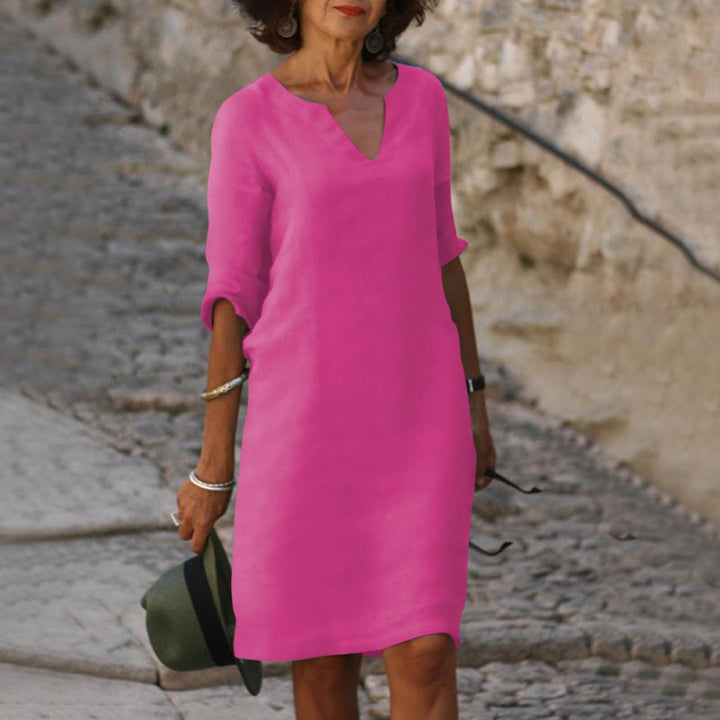 Versatile women's midi shift dress, V-neck and 3/4 sleeves for chic casual wear.