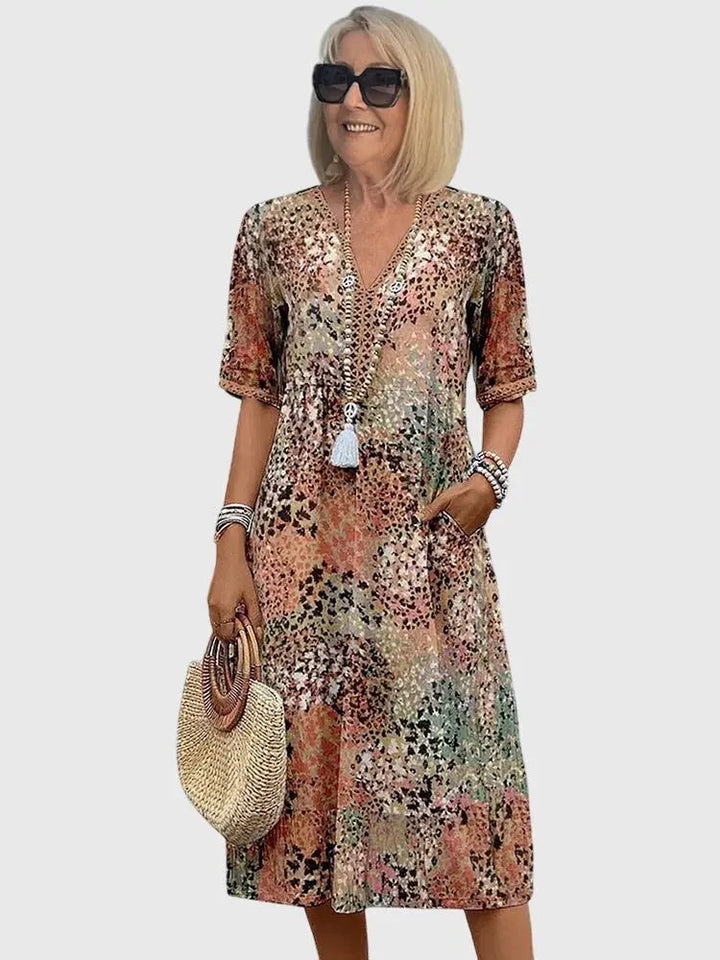 Women's V-neck mixed print midi dress. Elegant floral & geometric patterns, half sleeves, practical pockets.