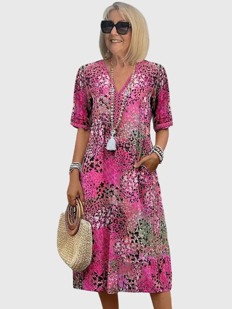 Versatile women's mixed print V-neck midi dress. Comfortable half sleeves, convenient pockets for everyday wear.