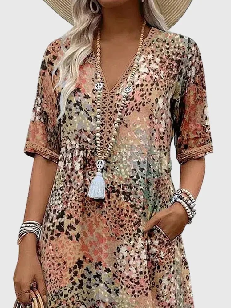 Stylish women's summer/spring V-neck midi dress. Unique mixed prints, half sleeves, and essential pockets for comfort.