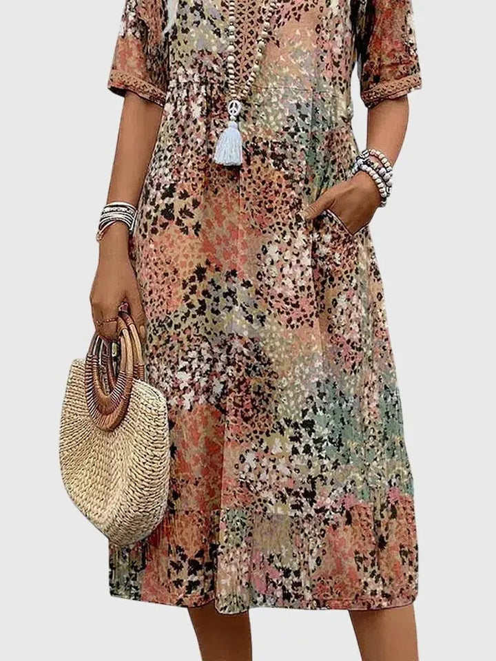 Fashionable women's V-neck midi dress. Unique mixed print design, practical half sleeves, and discreet pockets.