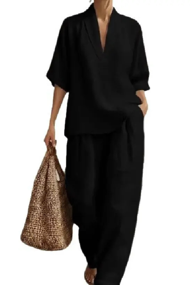 Elegant women's v-neck top & wide leg trousers two-piece co-ord set. Versatile for casual or dressy occasions.