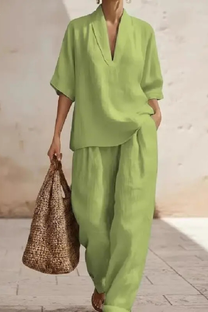 Casual elegant women's two-piece set with a V-neck top & wide leg trousers. Versatile fashion for any occasion.