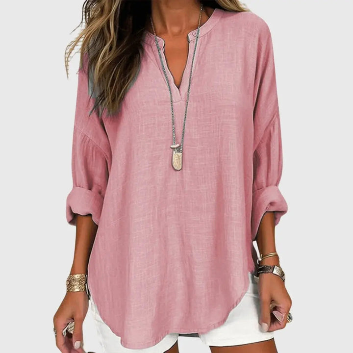 Stylish women's relaxed fit V-neck tunic top with long sleeves, great for versatile casual fashion.