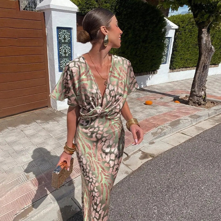 Figure-flattering animal print midi dress with V-neck & twist-front. Ideal wedding guest or party dress.
