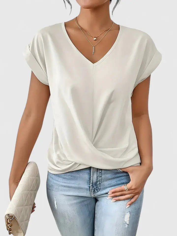Detailed view of a women's V-neck twist front short sleeve top, showcasing its flattering design & soft fabric.