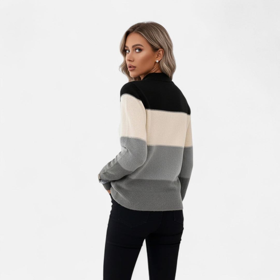 Close-up of a women's striped crew neck pullover sweater, highlighting the soft knit texture and versatile design.