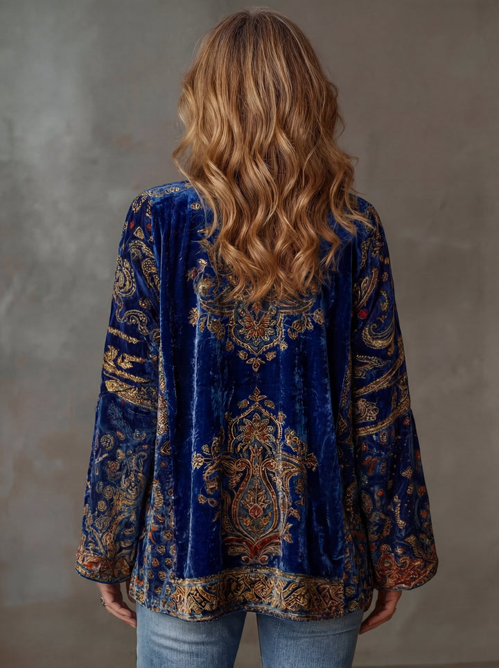Full view of a women's velvet-touch bohemian cardigan with flowy, artistic patterns. Elegant and relaxed fit layering.