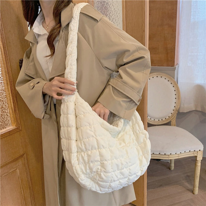 Stylish women's lightweight down shoulder bag, ideal for travel. Spacious versatile tote for essentials on the go.