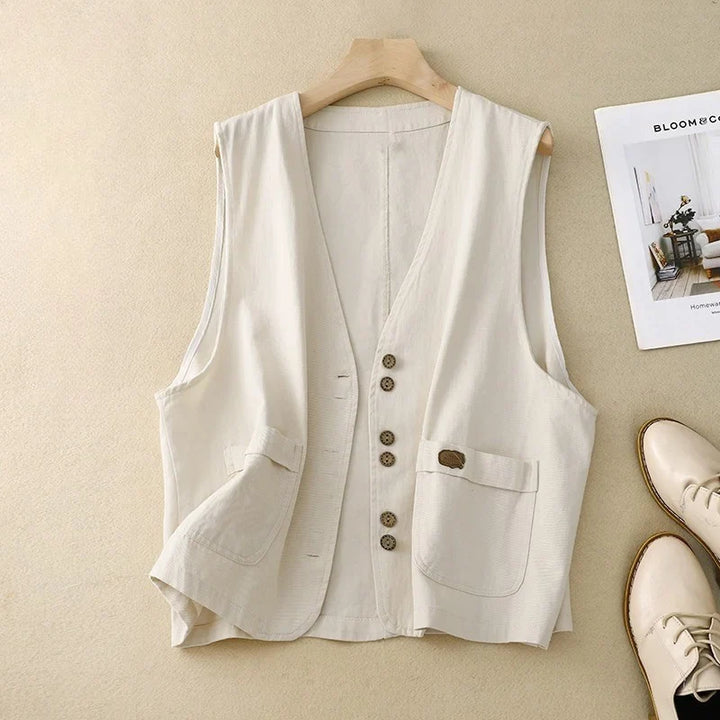 Women's versatile sleeveless vest with button front, V-neck, & patch pockets. Perfect for layering or casual wear.