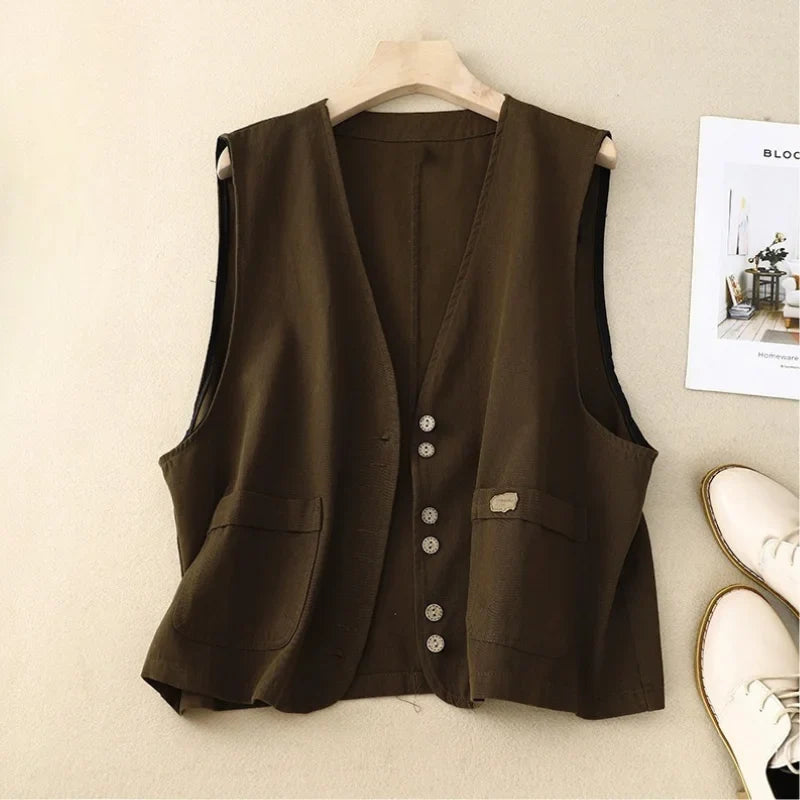 Stylish women's sleeveless button-front vest with patch pockets & V-neck. Versatile top for casual or elegant looks.