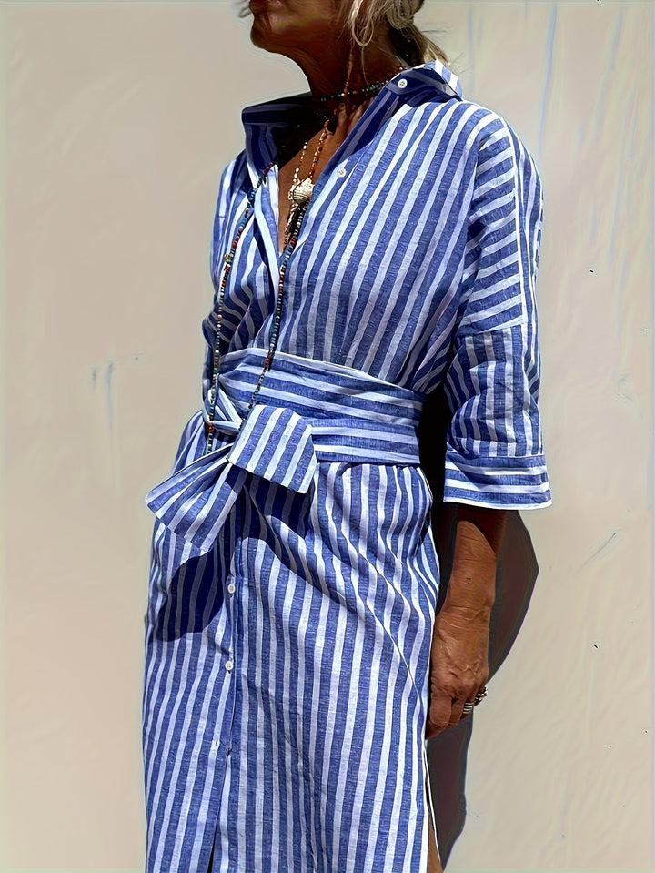Women's vibrant blue striped button-front shirt dress with belt, three-quarter sleeves.