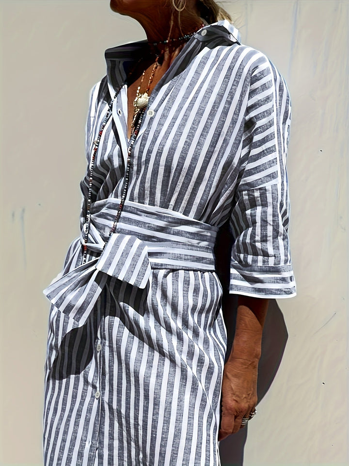 Stylish red striped button-front midi shirt dress with belt, three-quarter sleeves & split hem.