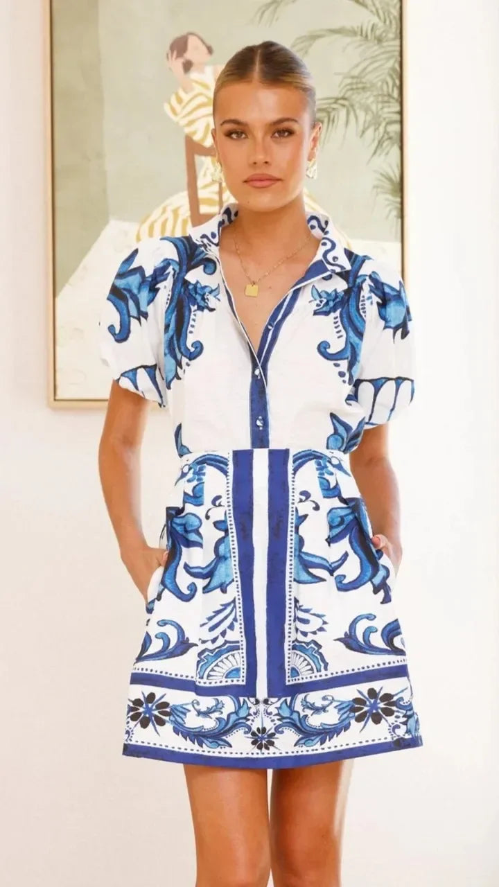 Women's summer fashion floral dress, puff sleeves, short length, vibrant.