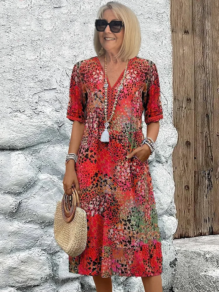 Stylish women's midi dress featuring a vibrant, colorful print and elegant flowing silhouette. Versatile fashion piece.