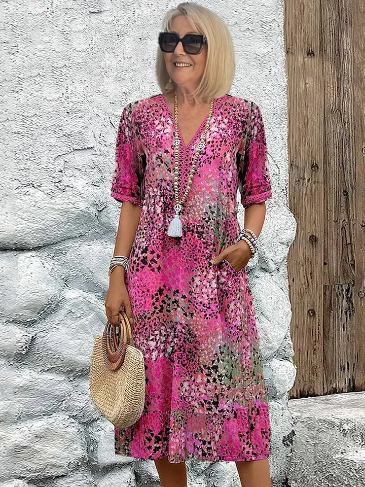 Elegant women's midi dress with a bold vibrant pattern & flowing silhouette. A statement piece for any occasion.