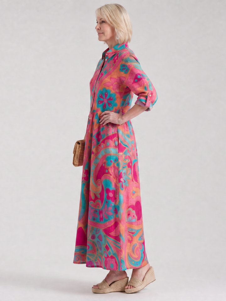 Detailed view of women's printed midi dress, featuring collared neckline, button front, and unique summer pattern.